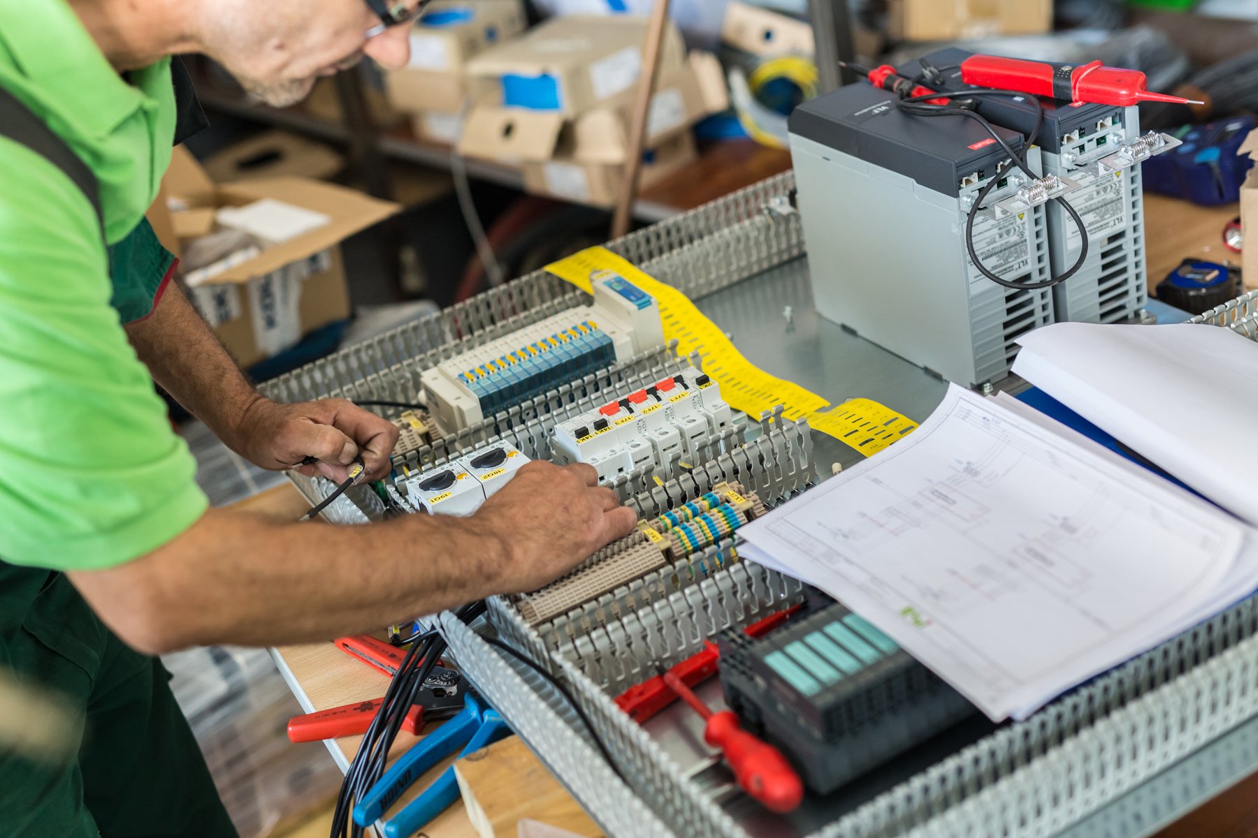 Electrician Assembling Industrial Electric Cabinet at Workshop